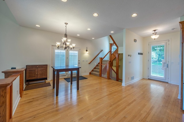 5108 Drummond Rd, Mound, MN 55364 - dining area featuring a chandelier, light wood-style flooring, stairway, and recessed lighting