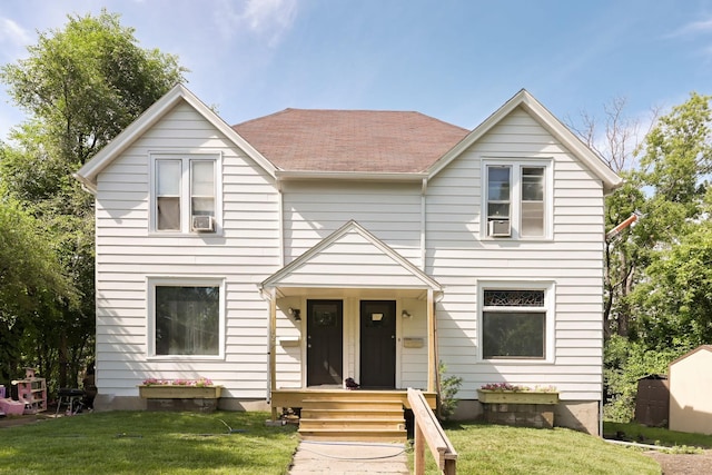 129 Morton St E, Saint Paul, MN 55107 - view of front of house with a front lawn and a shingled roof
