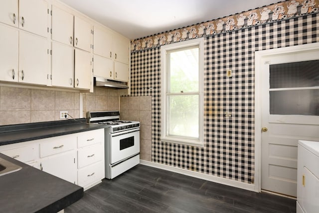 129 Morton St E, Saint Paul, MN 55107 - kitchen featuring white gas range oven, under cabinet range hood, dark wood-style floors, dark countertops, and white cabinets