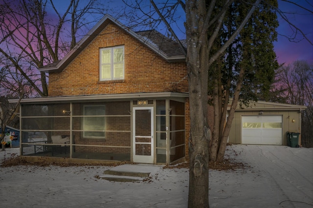 350 Harrison St W, Annandale, MN 55302 - view of front of property with a sunroom, brick siding, and a garage