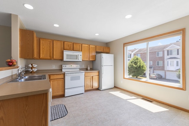 4964 Emmit Dr N Unit 3, Hugo, MN 55038 - kitchen with white appliances, recessed lighting, light countertops, and brown cabinets
