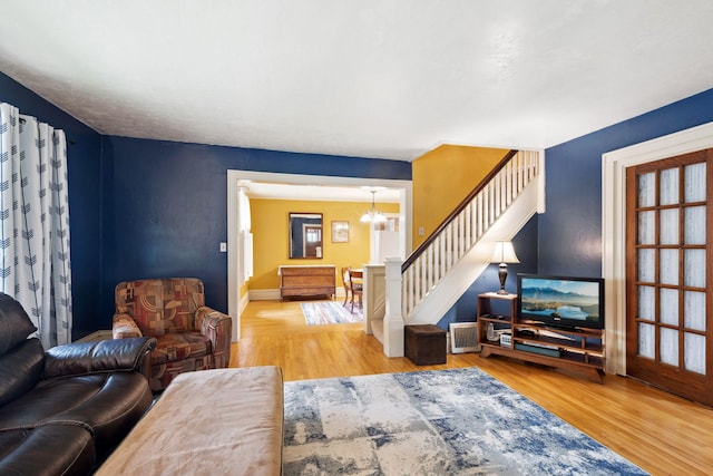 818 7th St S, Stillwater, MN 55082 - living room featuring a chandelier, wood finished floors, and stairs