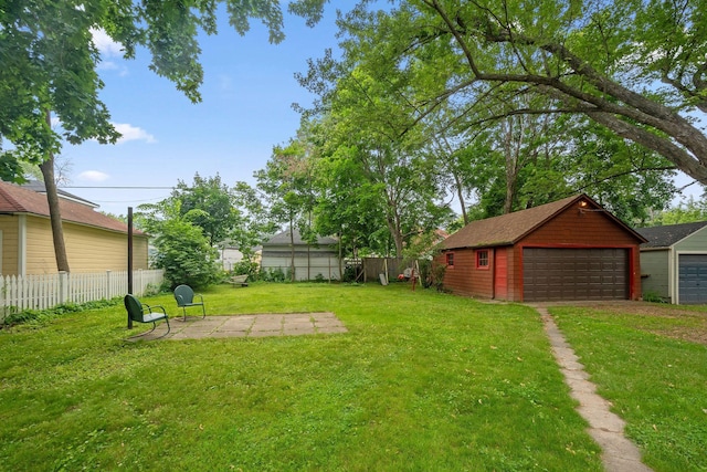 818 7th St S, Stillwater, MN 55082 - fenced backyard with a garage, an outbuilding, and a patio area