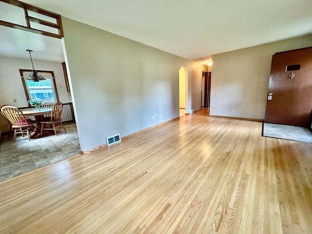 7520 14th Ave S, Richfield, MN 55423 - empty room featuring arched walkways and wood finished floors