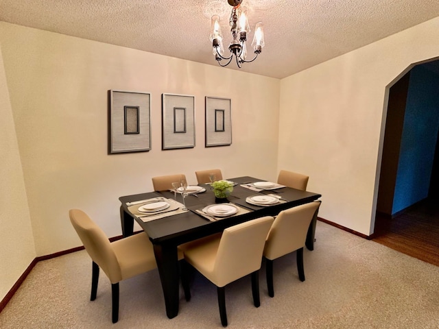 7520 14th Ave S, Richfield, MN 55423 - dining room featuring carpet floors, arched walkways, a chandelier, and a textured ceiling
