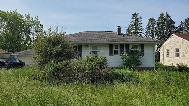 48 Buffalo St, Duluth, MN 55811 - view of front facade featuring a garage and a chimney