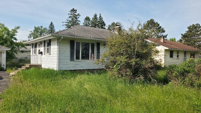48 Buffalo St, Duluth, MN 55811 - view of side of home featuring a chimney