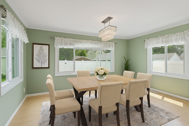 3137 Hampshire Ave S, Saint Louis Park, MN 55426 - dining room featuring light wood-type flooring, ornamental molding, and a chandelier