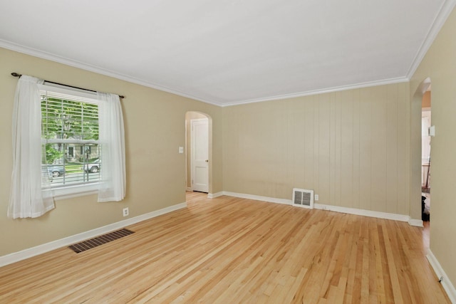 3137 Hampshire Ave S, Saint Louis Park, MN 55426 - unfurnished room with arched walkways, wood finished floors, and ornamental molding