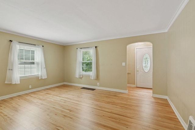 3137 Hampshire Ave S, Saint Louis Park, MN 55426 - empty room featuring arched walkways, crown molding, and light wood finished floors