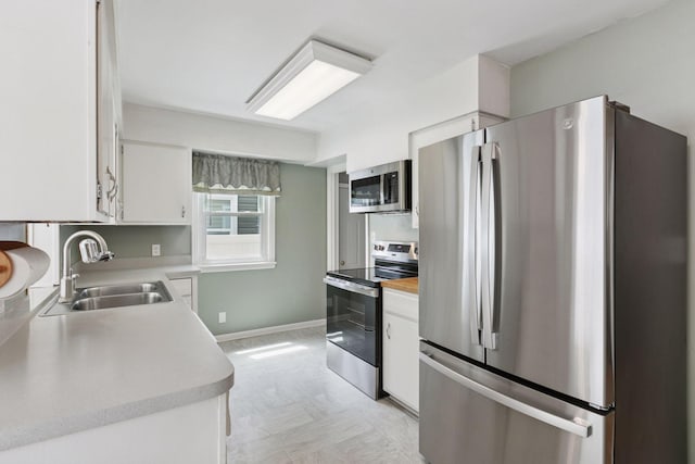 3137 Hampshire Ave S, Saint Louis Park, MN 55426 - kitchen featuring appliances with stainless steel finishes, white cabinetry, light countertops, and light flooring