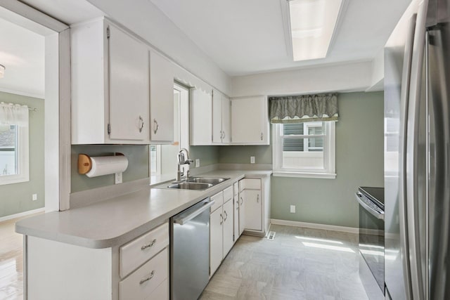3137 Hampshire Ave S, Saint Louis Park, MN 55426 - kitchen featuring appliances with stainless steel finishes, plenty of natural light, light countertops, and white cabinetry