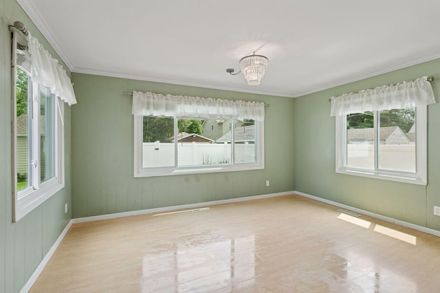 3137 Hampshire Ave S, Saint Louis Park, MN 55426 - unfurnished room with healthy amount of natural light, ornamental molding, a chandelier, and wood finished floors