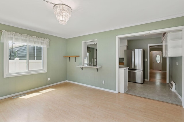3137 Hampshire Ave S, Saint Louis Park, MN 55426 - empty room featuring light wood-type flooring, a chandelier, and ornamental molding