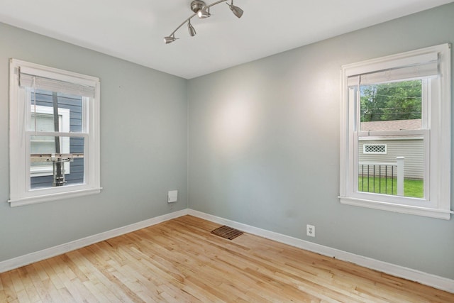 3137 Hampshire Ave S, Saint Louis Park, MN 55426 - unfurnished room featuring wood finished floors and rail lighting