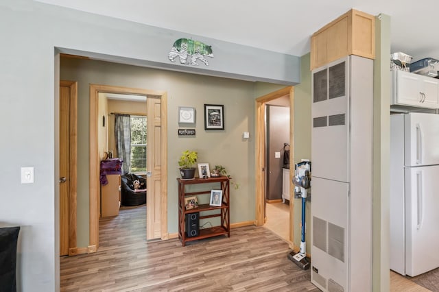 11711 County Rd, B, Lake Nebagamon, WI 54849 - hallway featuring light wood-style flooring and a heating unit