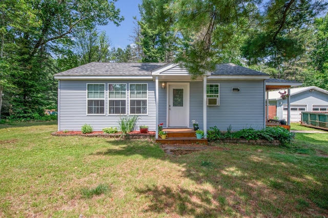11711 County Rd, B, Lake Nebagamon, WI 54849 - view of front facade with a front lawn, roof with shingles, and a carport
