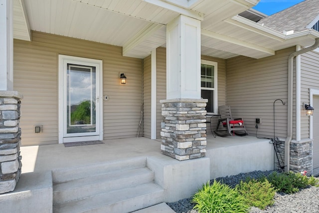 24000 Helium Ct, Forest Lake, MN 55025 - view of exterior entry with covered porch, stone siding, and roof with shingles
