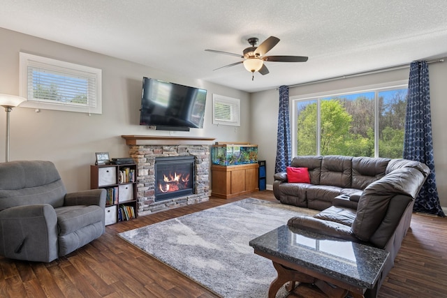 24000 Helium Ct, Forest Lake, MN 55025 - living area featuring a ceiling fan, a fireplace, dark wood finished floors, and a textured ceiling
