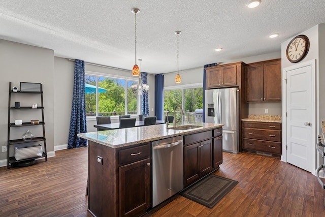 24000 Helium Ct, Forest Lake, MN 55025 - kitchen featuring appliances with stainless steel finishes, dark wood finished floors, a textured ceiling, a kitchen island with sink, and recessed lighting