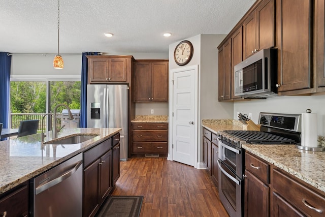 24000 Helium Ct, Forest Lake, MN 55025 - kitchen with appliances with stainless steel finishes, dark wood-type flooring, a textured ceiling, light stone countertops, and decorative light fixtures