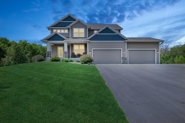 24000 Helium Ct, Forest Lake, MN 55025 - craftsman house featuring driveway, a porch, a front lawn, and an attached garage