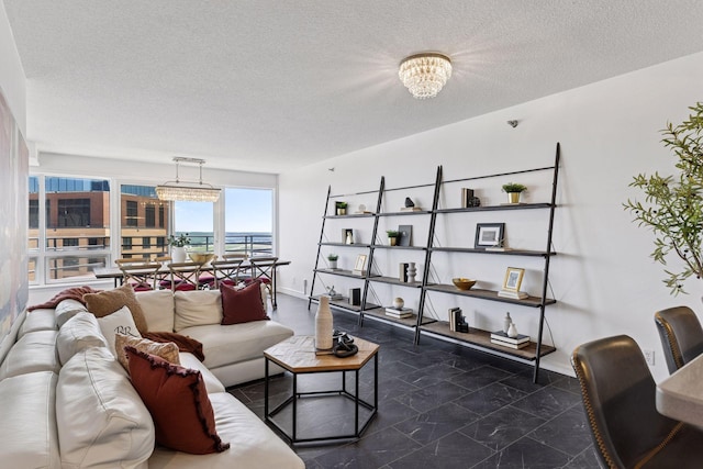 168 6th St E Unit 3004, Saint Paul, MN 55101 - living room featuring a textured ceiling and a chandelier