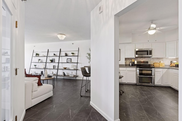168 6th St E Unit 3004, Saint Paul, MN 55101 - kitchen with stainless steel appliances, dark marble finish floors, ceiling fan, and white cabinetry