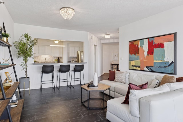 168 6th St E Unit 3004, Saint Paul, MN 55101 - living area featuring a textured ceiling and a chandelier