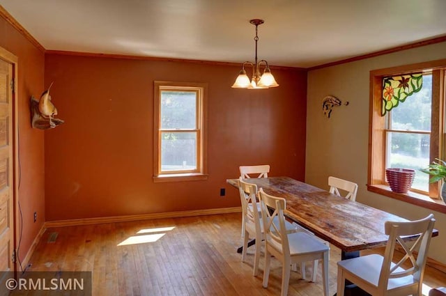 1217 83rd Ave, Lincoln Twp, WI 54001 - dining space featuring hardwood / wood-style flooring, crown molding, and a chandelier