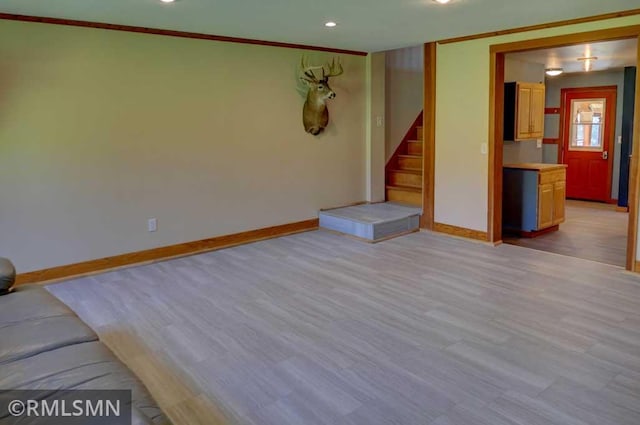 1217 83rd Ave, Lincoln Twp, WI 54001 - unfurnished living room featuring stairs, ornamental molding, light wood-type flooring, and recessed lighting