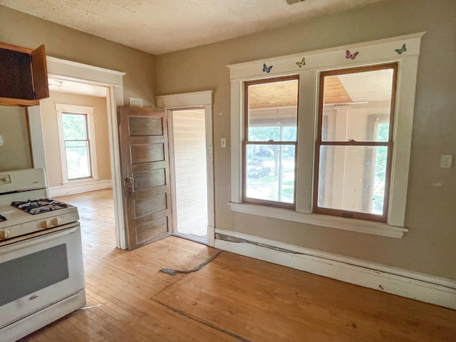 629 Farrington St, Saint Paul, MN 55103 - kitchen featuring gas range gas stove, light wood finished floors, and a baseboard heating unit