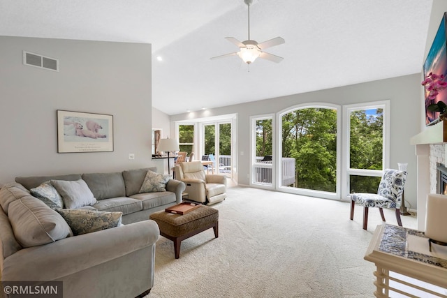 13840 Edenwood Way, Apple Valley, MN 55124 - living area with light carpet, a glass covered fireplace, ceiling fan, and high vaulted ceiling