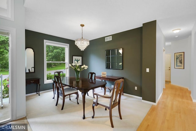 13840 Edenwood Way, Apple Valley, MN 55124 - dining area featuring plenty of natural light, light wood-style flooring, and a chandelier