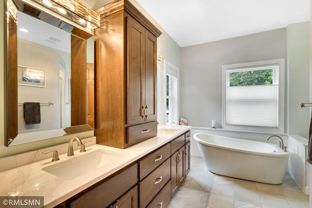 13840 Edenwood Way, Apple Valley, MN 55124 - full bathroom with double vanity, a freestanding bath, and tile patterned flooring