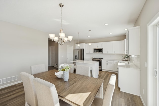 757 Greywood Blvd SW, Delano, MN 55328 - dining space featuring wood finished floors, a chandelier, and recessed lighting