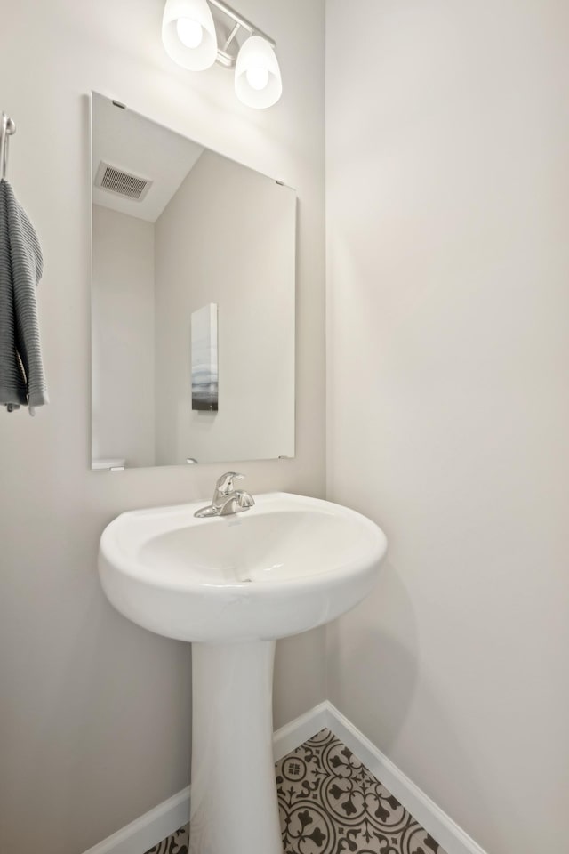 757 Greywood Blvd SW, Delano, MN 55328 - bathroom featuring a sink and tile patterned floors