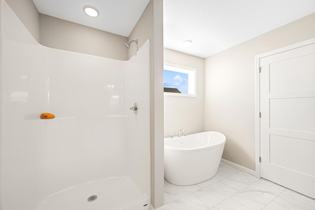 757 Greywood Blvd SW, Delano, MN 55328 - full bathroom featuring marble look tiles, a soaking tub, and a shower