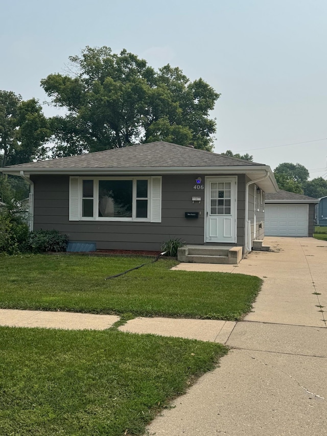 406 22nd St S, Fargo, ND 58103 - single story home featuring a garage, driveway, a front lawn, and an outbuilding