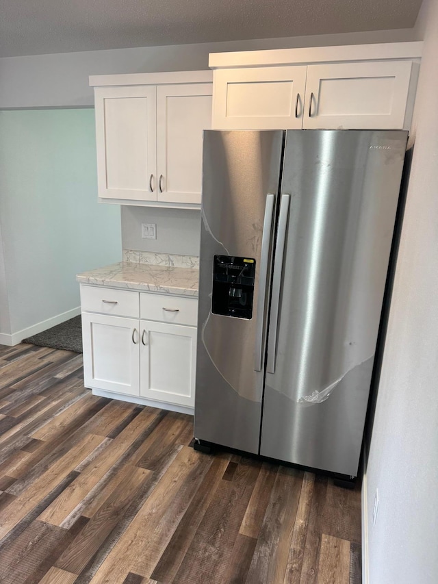 406 22nd St S, Fargo, ND 58103 - kitchen featuring stainless steel fridge, dark wood-type flooring, white cabinets, and light stone countertops