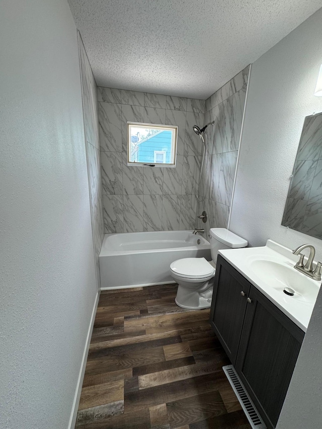 406 22nd St S, Fargo, ND 58103 - full bath featuring a textured ceiling, vanity, wood finished floors, shower / washtub combination, and a textured wall