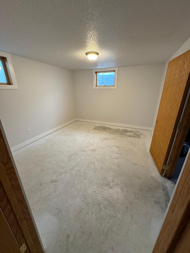 406 22nd St S, Fargo, ND 58103 - below grade area featuring a textured ceiling and baseboards