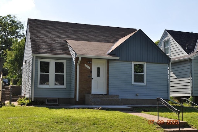 4004 19th Ave S, Minneapolis, MN 55407 - view of front of house with a front lawn, board and batten siding, and entry steps