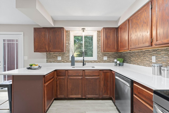 6494 Bonner Ct, Inver Grove Heights, MN 55076 - kitchen with dishwasher, a peninsula, tasteful backsplash, light countertops, and light wood-style flooring