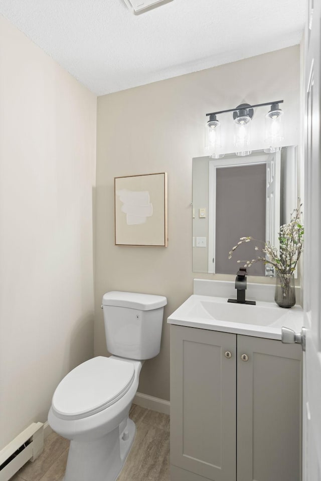 6494 Bonner Ct, Inver Grove Heights, MN 55076 - bathroom featuring a baseboard radiator, vanity, and wood finished floors