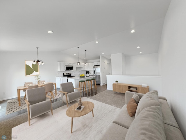 4832 51st Ave S, Fargo, ND 58104 - living room with lofted ceiling, a chandelier, and recessed lighting