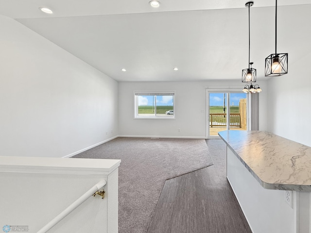 4832 51st Ave S, Fargo, ND 58104 - unfurnished living room featuring healthy amount of natural light, recessed lighting, a chandelier, and dark colored carpet