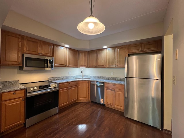 2485 Londin Ln E Unit 418, Maplewood, MN 55119 - kitchen with appliances with stainless steel finishes, dark wood-style flooring, light stone counters, decorative light fixtures, and brown cabinets
