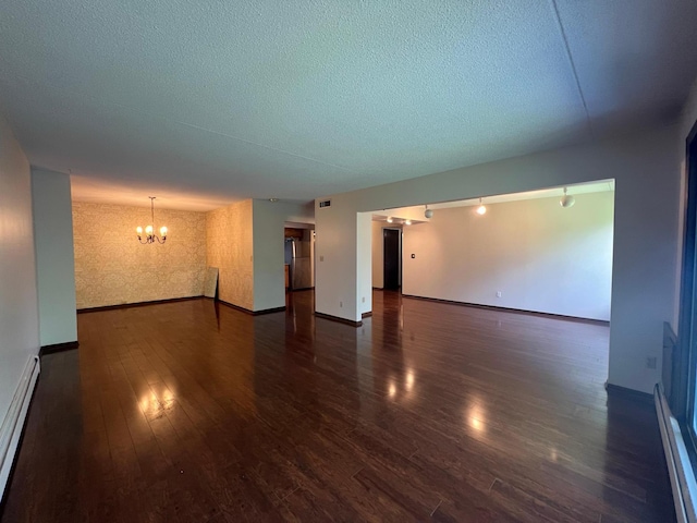 2485 Londin Ln E Unit 418, Maplewood, MN 55119 - unfurnished room featuring a chandelier, baseboard heating, wood finished floors, and a textured ceiling