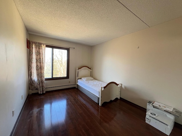 2485 Londin Ln E Unit 418, Maplewood, MN 55119 - bedroom featuring a baseboard heating unit, a textured ceiling, and wood-type flooring